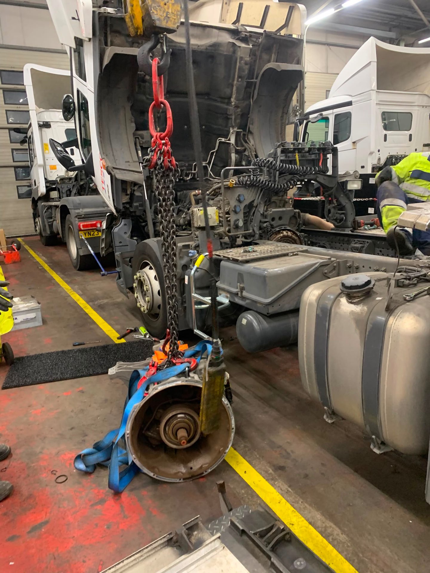 Technician working on a heavy vehicle gearbox
